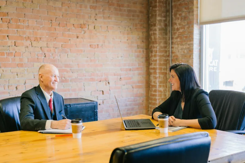 Two professionals having a conversation in an office